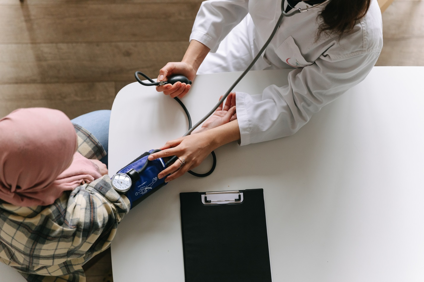  A doctor checking the blood pressure of a woman 