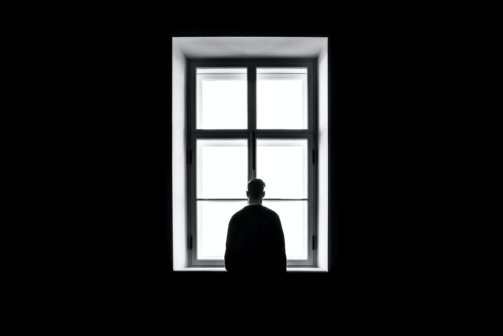  a man standing in front of a window